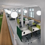 Internal view of the converted factory building: workplaces in the modern open-plan office.