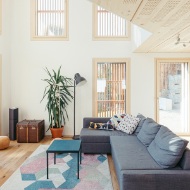 igh-ceilinged living room with plenty of windows as well as a wooden ceiling and floor