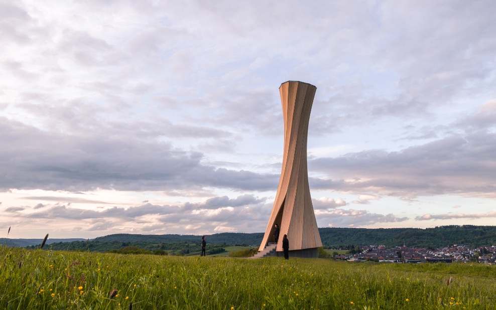 Overall view of the Urbach Tower at dawn. Some people viewing the tower and its specially formed wooden structure from the inside, enjoying the sweeping views across the house rooftops.