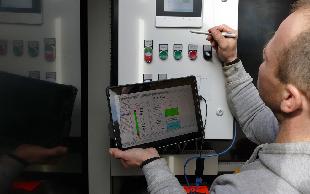 Un collaborateur de BL Silobau AG consulte les données d’une installation de silo dans le portail de maintenance à l’aide d’une tablette